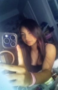 Yaretzi takes a mirror picture.