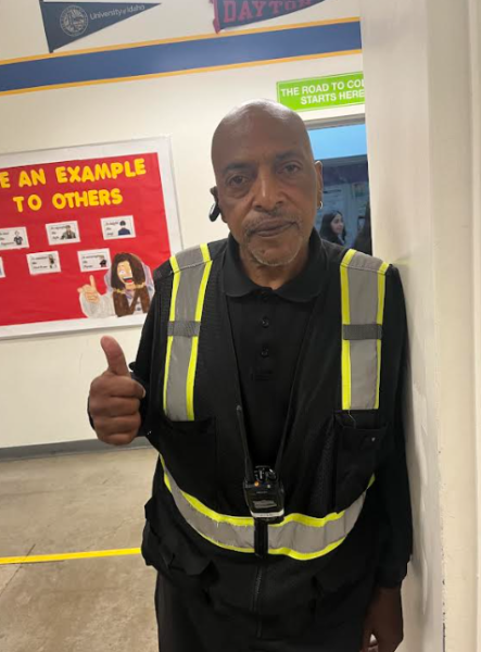 Mr. Beck doing a thumbs up by the restroom.
